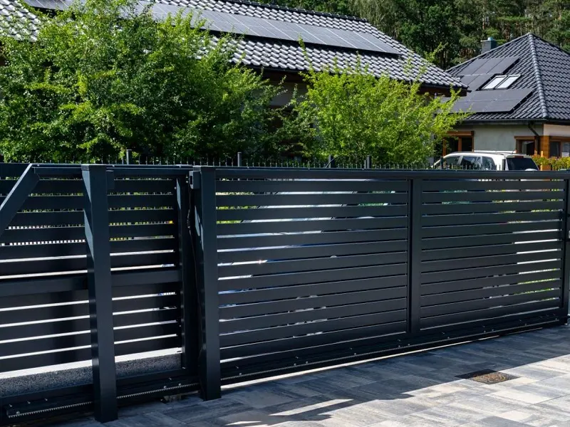 Ornamental iron fence installed at residential community entrance