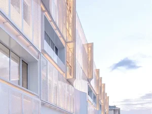 Modern building facade made with perforated metal sheets showing light and shadow effects