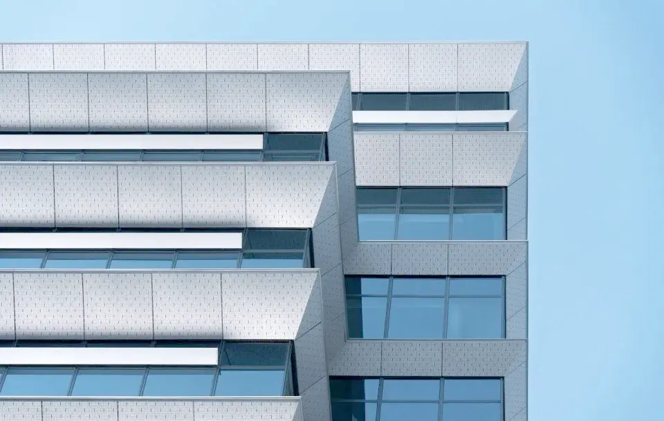 Facade installation of large-format perforated metal sheets with support frame